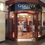 Godiva to close 128 stores in North America In North America, the success of this strategy is evidenced by the continued growth of GODIVA’s consumer base, which is largely being driven by online and greater product purchasing through its grocery, club, and retail partners